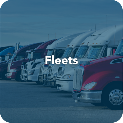 Row of semi trucks representing trucking fleets using freight factoring for faster payments and cash flow
